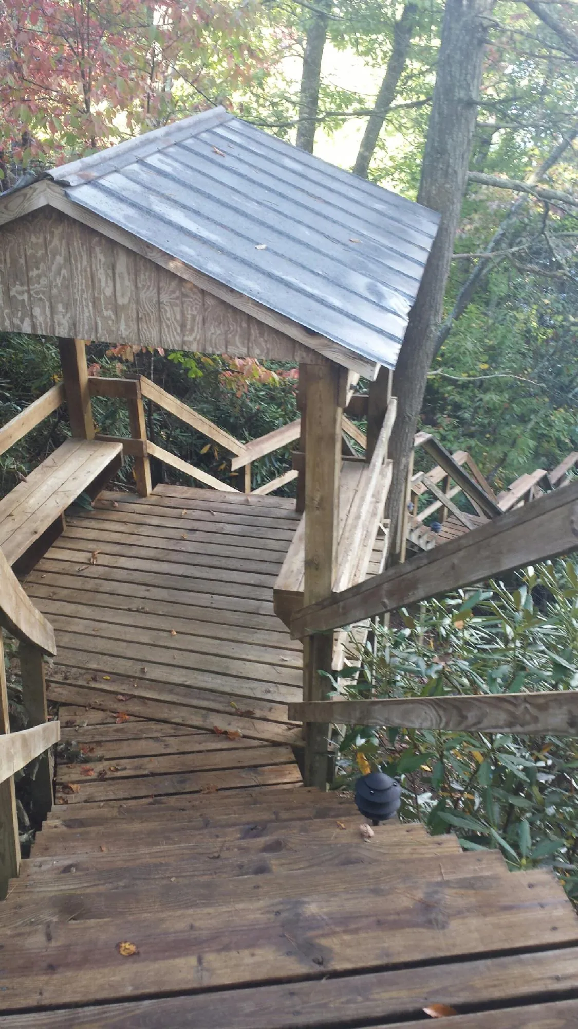 Metal roofed shelter over wooden steps on a wooded walkway — Skylight Repair & Installation work by our crew in Ballston Spa