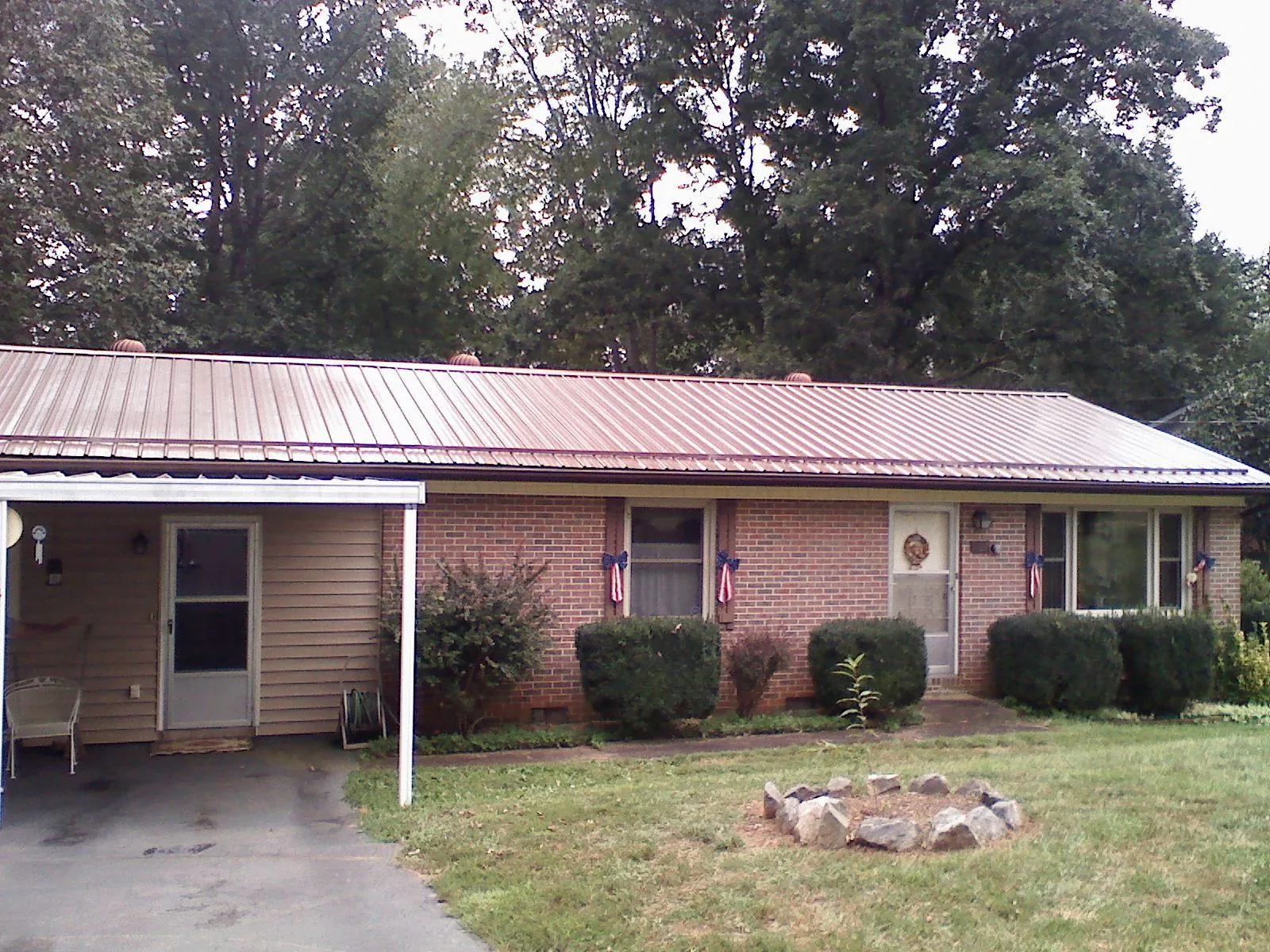Bronze metal roof and carport on a brick ranch home — Roof Repair work by our crew in Ballston Spa